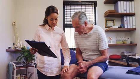 physiotherapist examining patients knee 4k