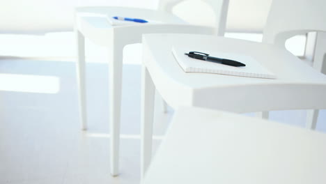 Notebook-with-pen-on-white-chair