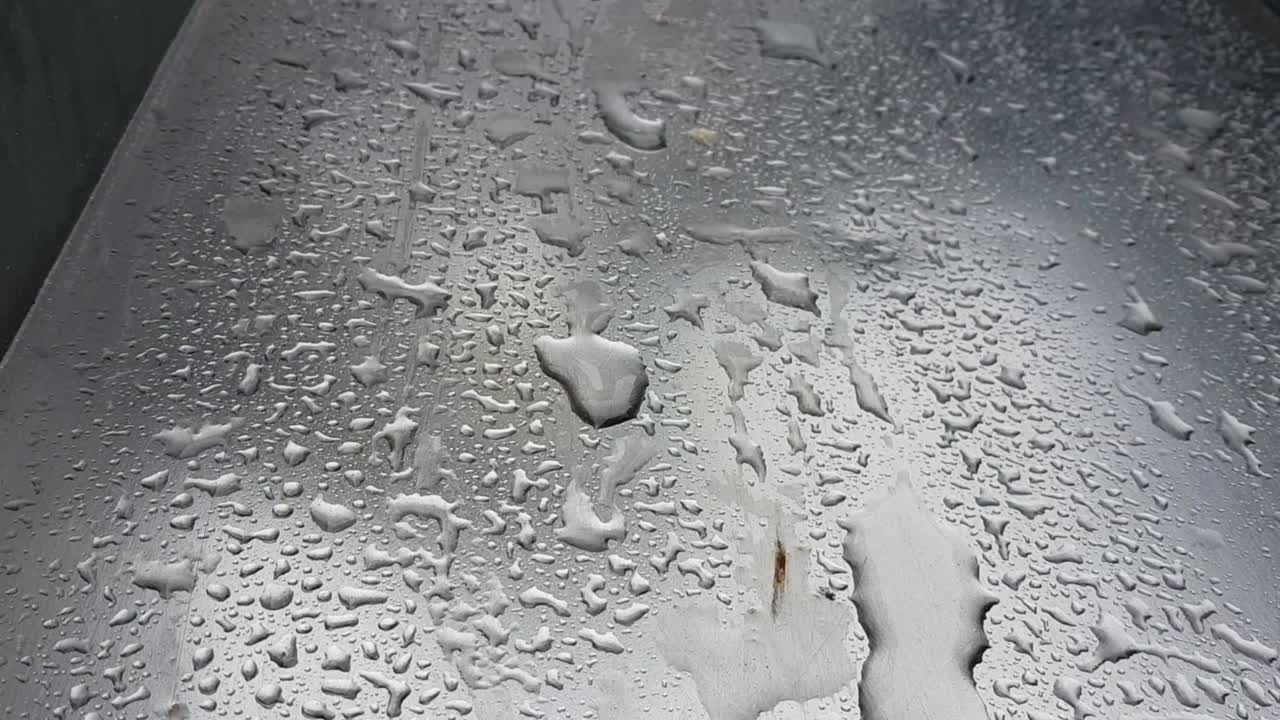 Close up view of wet silver metal slide, big water drops