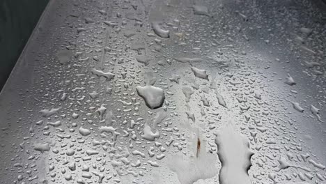 close up view of wet silver metal slide, big water drops