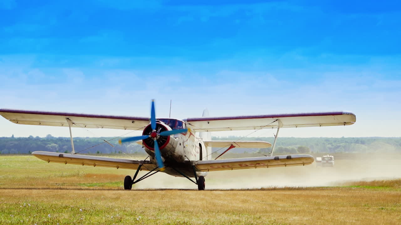 Vintage Biplane Taxiing on a Field