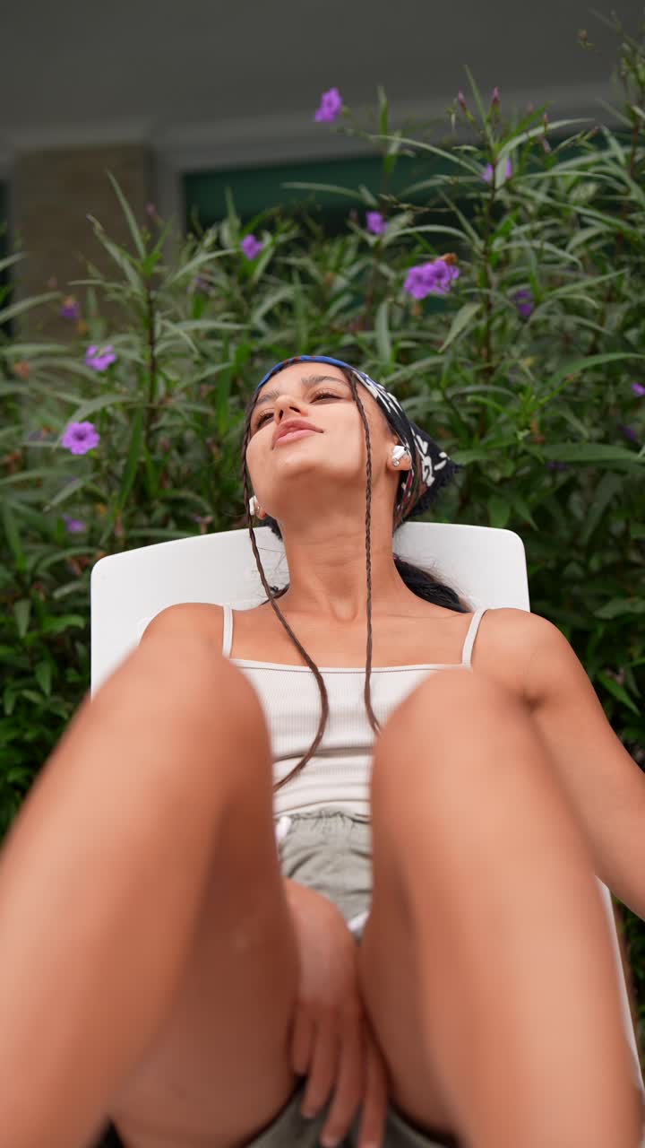 Woman Relaxing Outdoors Listening to Music