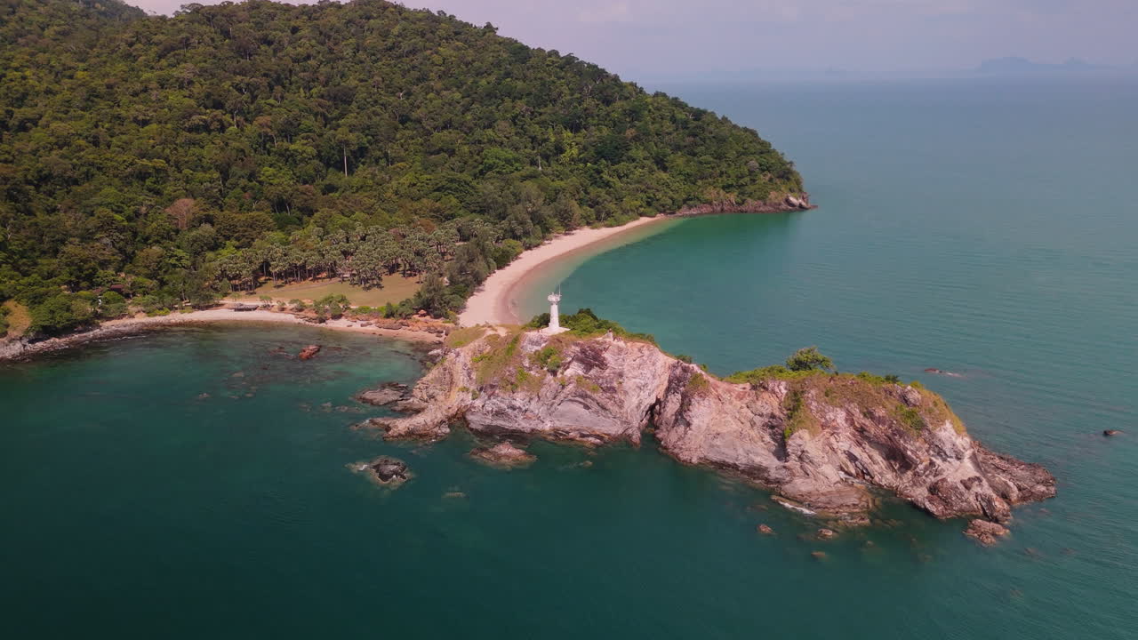 Aerial view of a tropical beach with a lighthouse