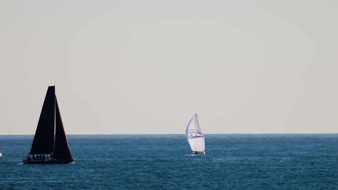 Nice, France - February 10, 2025: Multiple sailboats moving on the sea
