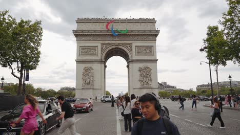 arc de triomphe in paris with paralympic symbol on a cloudy day