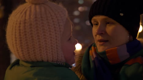 mother and child on a walk in winter evening