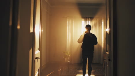 a person standing in a sunlit room