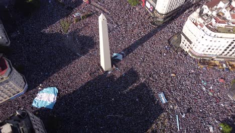 Argentines-crowd-celebrating-the-final-victory-of-soccer-World-Cup-2022-on-9th-July-Avenue-around-obelisk,-Buenos-Aires