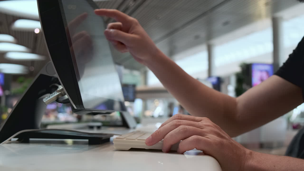 Person Using Airport Kiosk Touchscreen