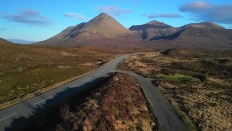 rise up over highland road revealing red cuillin mountains on isle of skye scotland