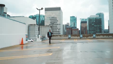 Businessman-going-on-empty-parking-and-talking-on-phone.-Man-speaking-by-phone