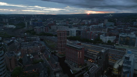 Establishing-Drone-Shot-of-Leeds-City-Centre-around-Leeds-Train-Station-in-Low-Light-and-Orange-Sunset-in-Distance-West-Yorkshire-UK