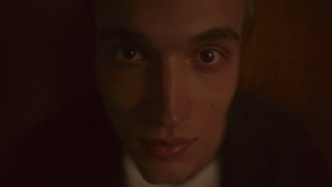 portrait of young man staring into camera in warm light