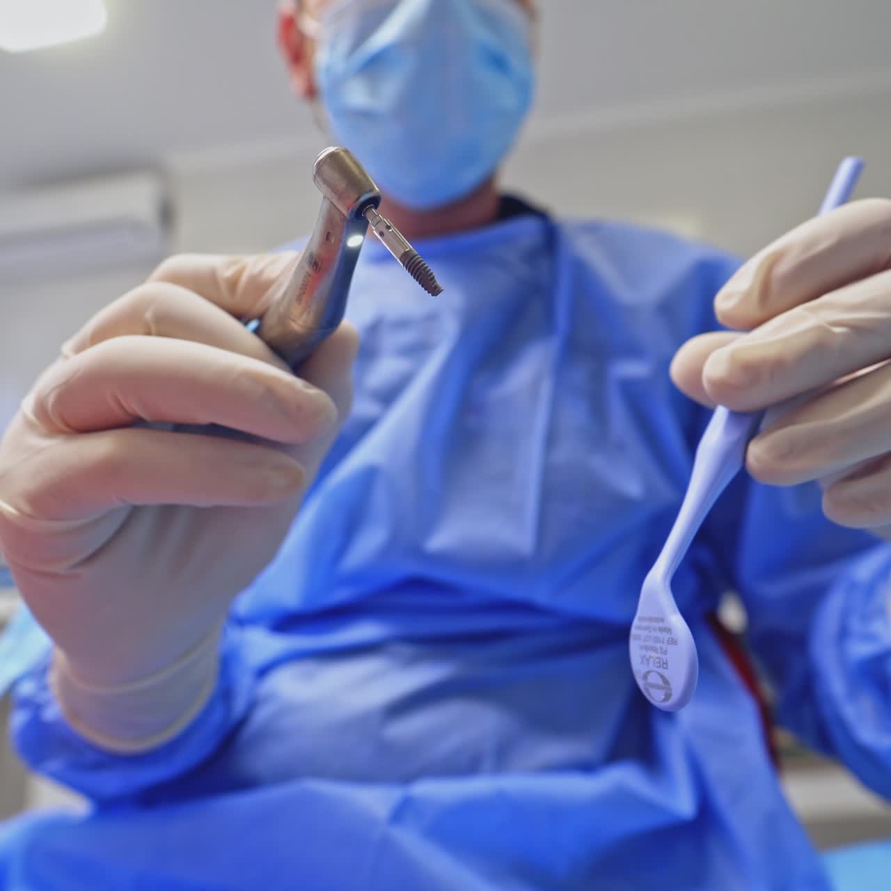 Hands holding dental tools