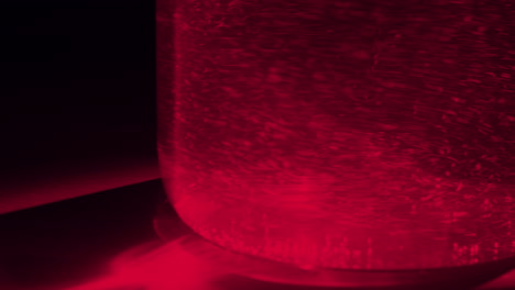 red liquid with bubbles in container