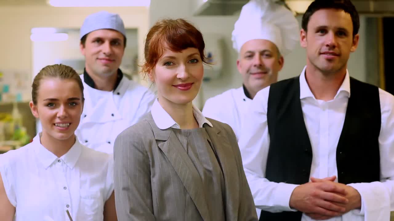 Restaurant team posing together smiling at camera