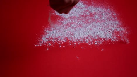 pouring powder on a red background