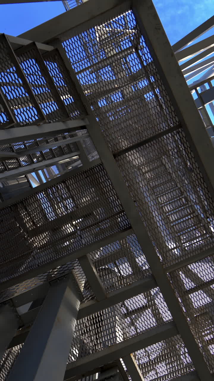 Steel construction of modern factory. Modern storehouse construction with metal structures of frame. Structural steel structure of new commercial building. Vertical video