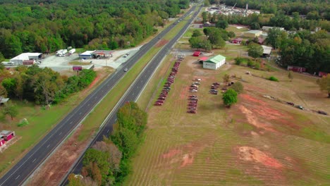 Cars-and-JB-Hunt-cargo-transportation-truck-on-interstate-highway-85-i-85-road-in-Alabama---old-cars-buried,-Sylacauga,-AL