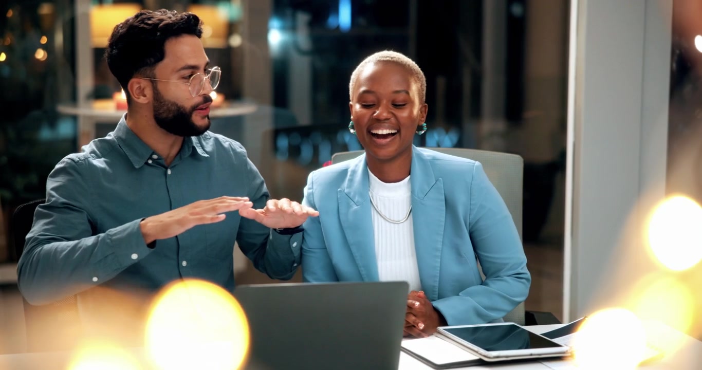 Two Business Professionals Collaborating on a Project in a Modern Office