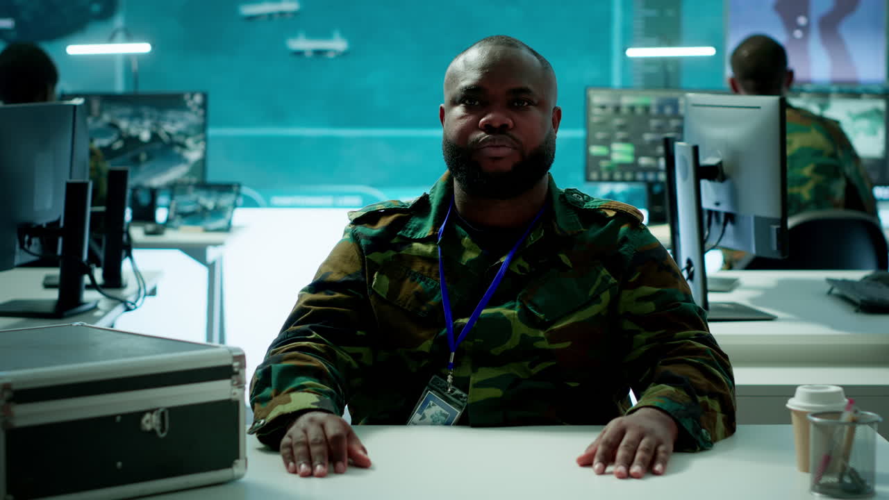 Reconnaissance expert engages in a online videocall in a high tech control room