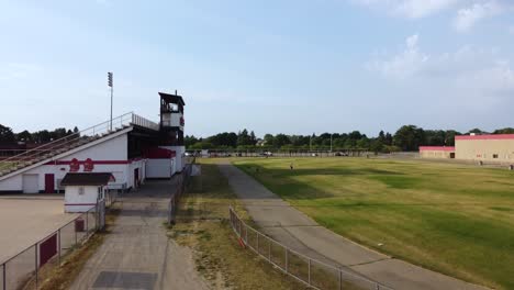 a drone descends over a decrepit high school track in east michigan