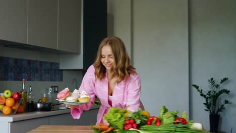 Smiling-girl-throwing-off-from-kitchen-table-fresh-vegetables