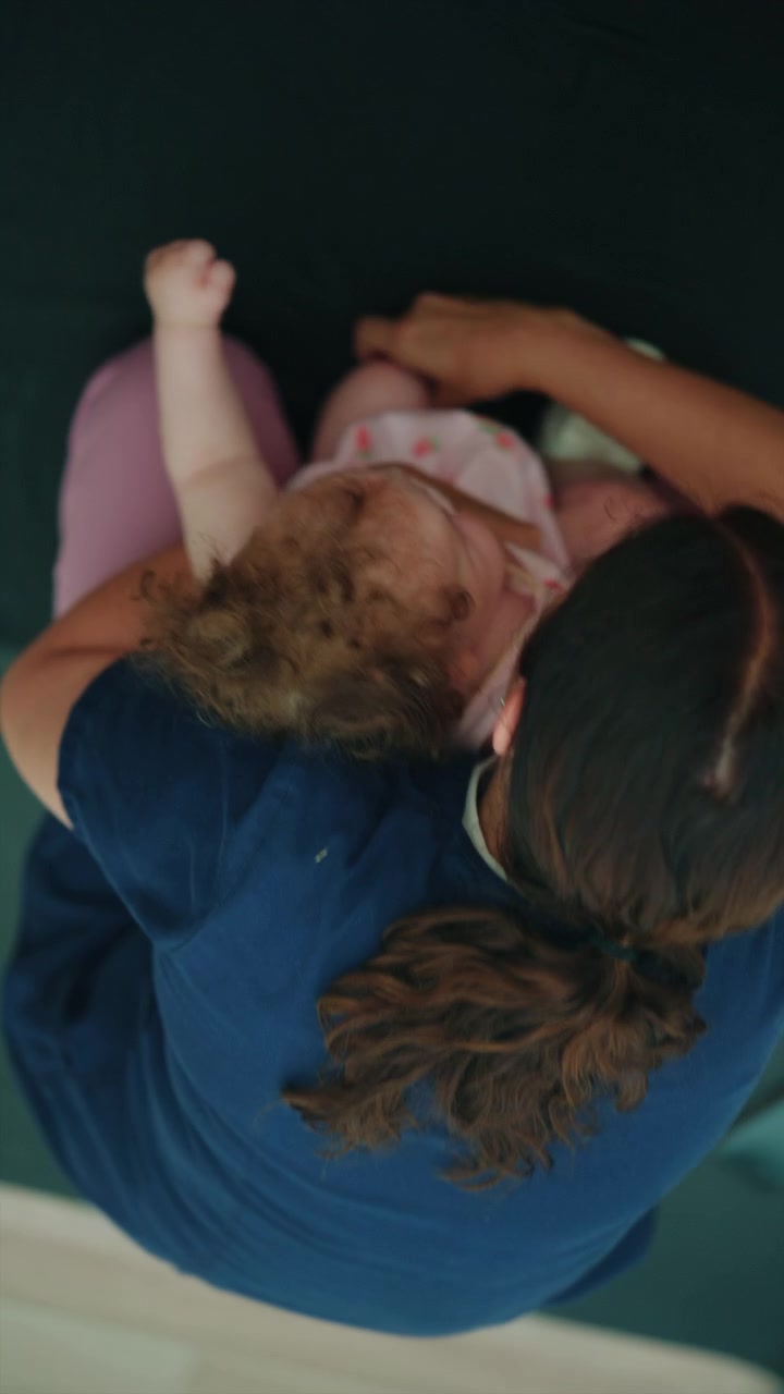 Therapist supporting an infant during physical therapy, aiding motor skill development and promoting health and well-being