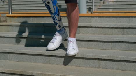 person with prosthetic leg walking up stairs