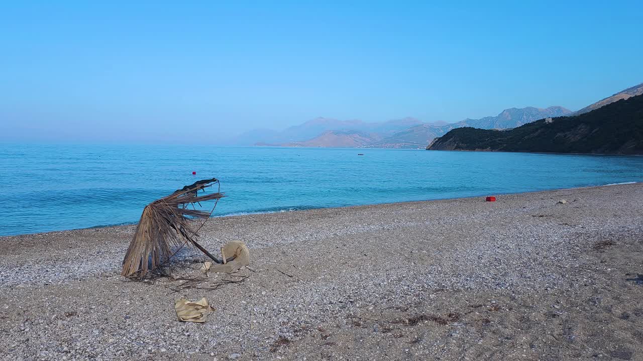 Lonely Shore: Abandoned Beach Umbrella at Lukova After the Bustle of Summer Vacation in Albania