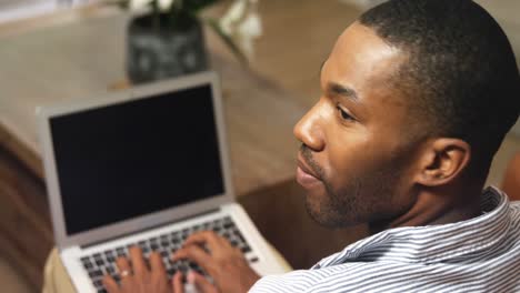 man using laptop at home 4k