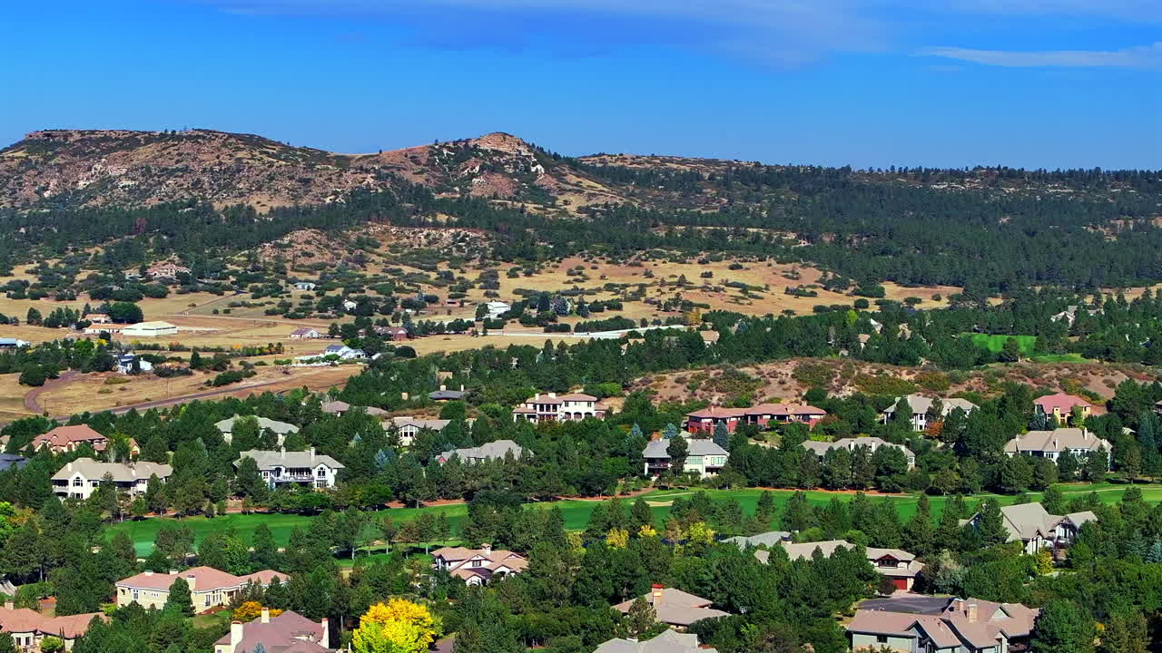 Daniels Park Castle Pines Village BMW Championship Golf Course winter spring aerial drone Colorado front range sunrise morning Castle Rock Sedalia neighborhood homes lush green grass blue sky upwards