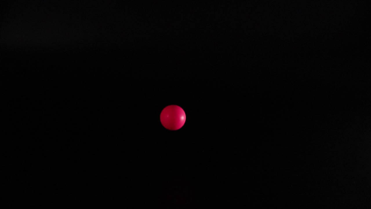 Red ball bouncing in dark environment