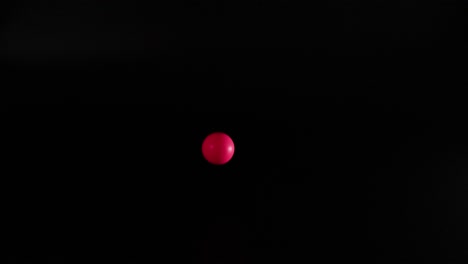 red ball bouncing in dark environment