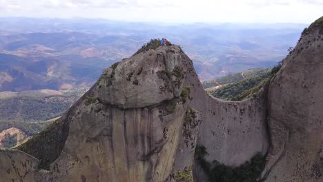 extreme climbing at pedra dos cinco pontões mountain, espírito santo, brazil. drone orbit shot.