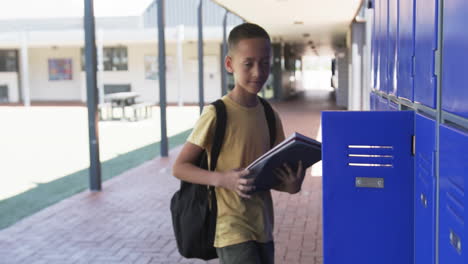back to school text over boy with backpack opening locker