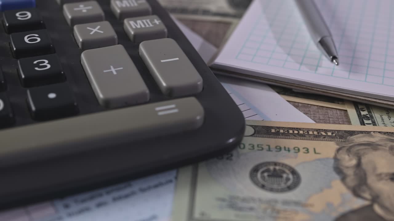 1040 Tax form with refund check and currency US dollar banknotes close-up