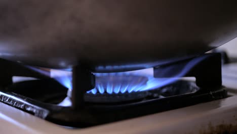 Light-A-Gas-Cooker,-blue-gas-ignites-frames-in-kitchen