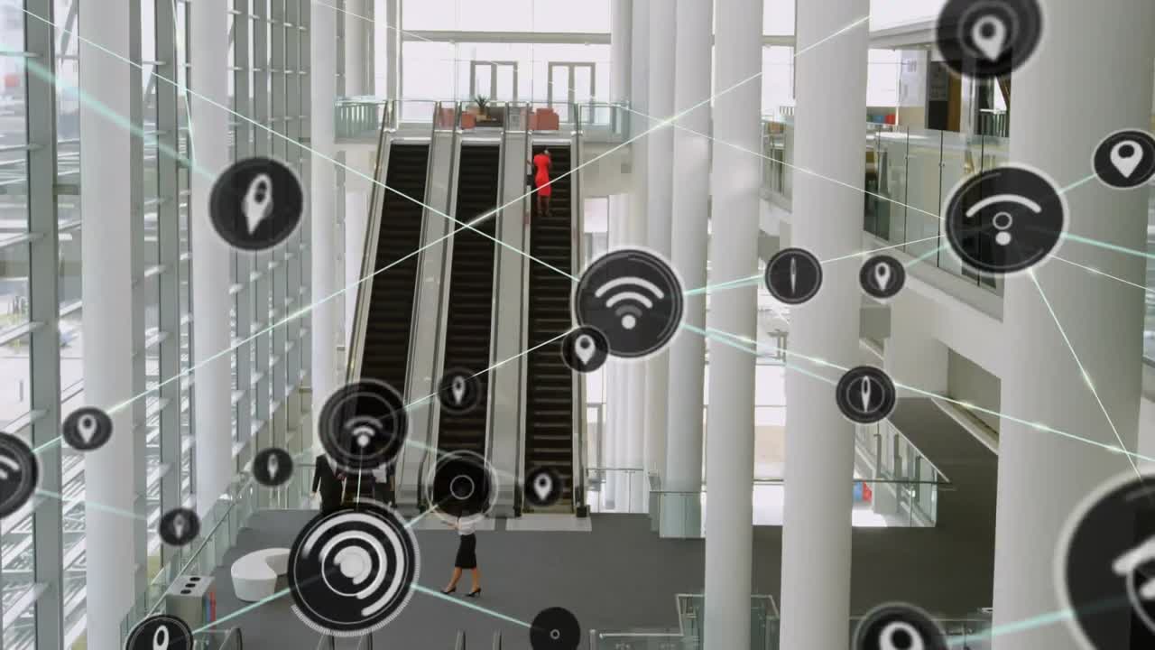Network of digital icons against overhead view of modern office