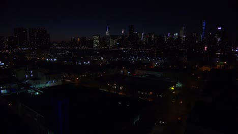 a wide angle view over queens new york city at dusk with the manhattan skyline background 2
