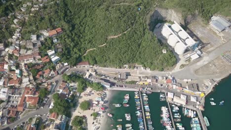 drone flies above arraial do cabo port and tilts up to reveal the beautiful landscape in the distance