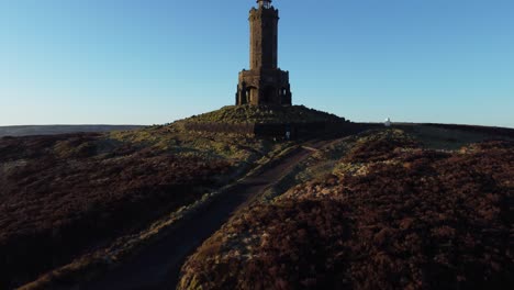 Darwen-Jubilee-tower-Lancashire-hillside-misty-valley-moorland-countryside-aerial-rising-shot