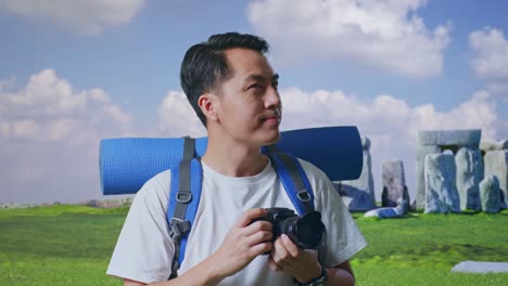 man with backpack taking pictures in historical site