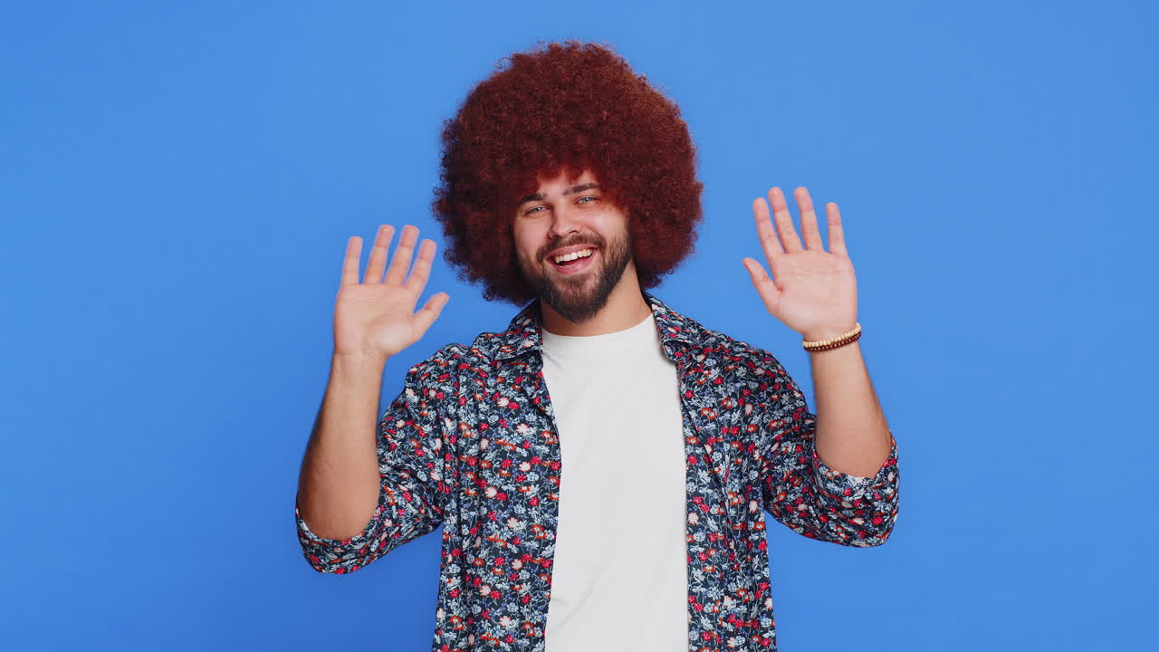 Happy man smiling friendly waving hands gesturing hello greeting or goodbye meeting invitation