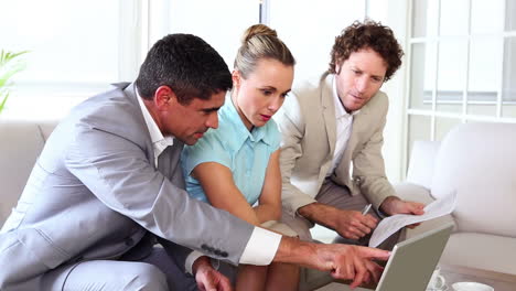 Business-people-working-together-on-sofa-with-laptop