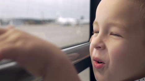 smiling boy looking out the bus window