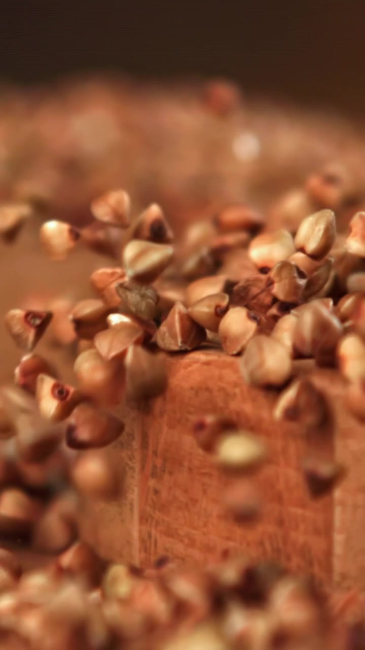Slow Motion Buckwheat Groats Falling on a Wooden Surface