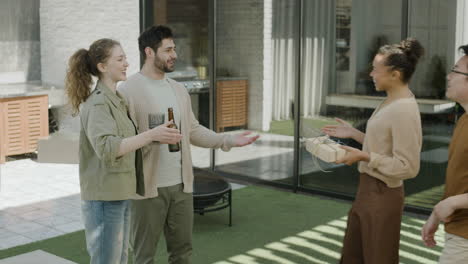 a multicultural group of friends greets each other as they arrive at a barbecue