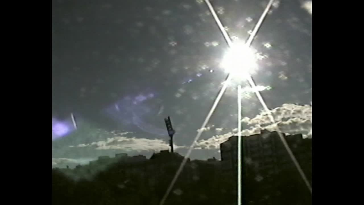 Urban skyline with dramatic sunburst and flare