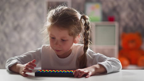 little child with long plaits counts on abacus at lesson